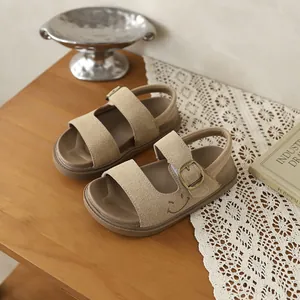 Dettaglio di sandali per bambini in pelle scamosciata kaki con ricamo smiley e velcro