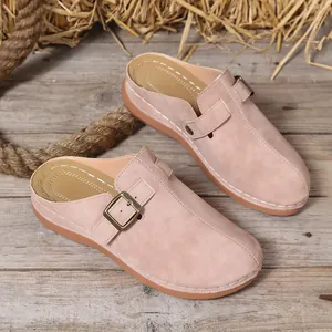 Detailed view of pink suede-textured closed-toe wedge sandals with buckle and stitching.