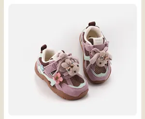 Detailed view of purple baby sneakers featuring cute plush rabbit and flower decorations