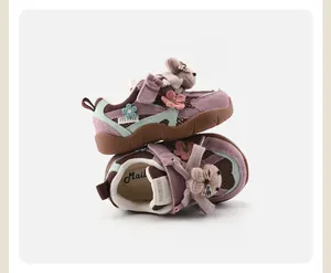 Detail view of purple toddler sports shoes with cute plush bear and flower decor