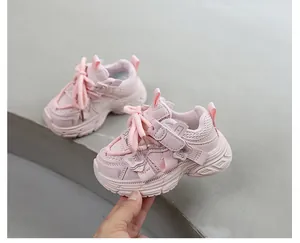 Primer plano de zapatillas de deporte rosas para niños con aplique de mariposa