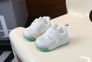 Detail view of breathable white mesh toddler shoes with green panda pattern