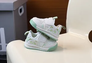 Detail of breathable mesh baby sneakers with cute green panda pattern and soft soles