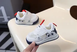 Breathable white mesh panda baby walking shoes with soft soles and red pull tabs