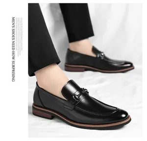 Detailed view of black leather loafers with metal buckle and wooden grain sole