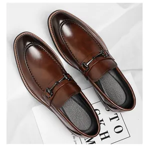 Close-up detail of brown men's loafers with metal bit and polished finish