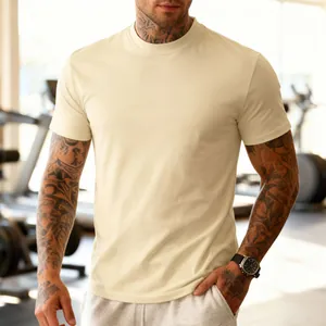 Close-up detail of a cream men's athletic T-shirt worn by a tattooed model in a gym
