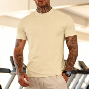 Close-up of a men's breathable cream gym t-shirt worn by a tattooed model