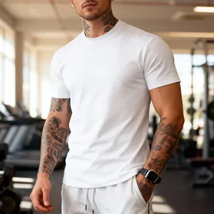 Detail shot of a white quick-dry fitness T-shirt on an athletic male model in a gym.