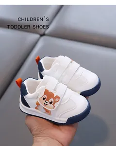 Close-up of white toddler walking shoes with cute squirrel pattern and velcro straps