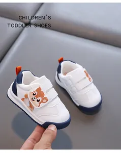 Close-up of white toddler walking shoes with cute cartoon chipmunk on Velcro straps