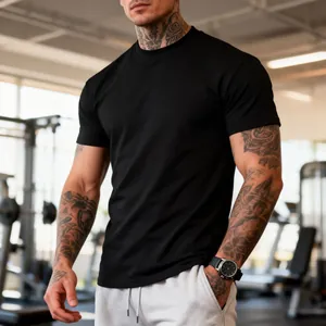 Close-up of men's athletic t-shirt showing fit and breathable fabric in gym setting.