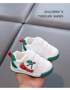Detail view of white toddler shoes featuring a cute cherry design and breathable mesh fabric