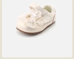 Detailed view of cream toddler girl walking shoe with lace bow and breathable mesh