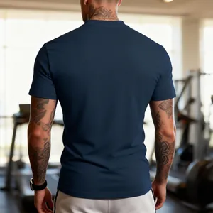 Back view of navy blue men's crew neck fitness T-shirt in a professional gym setting.