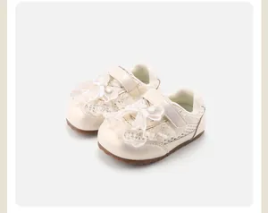 Close-up detail of cream baby girls' sneakers with decorative lace butterfly bows