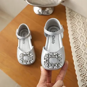 Detailed close-up of silver girls princess shoes featuring a sparkling rhinestone buckle