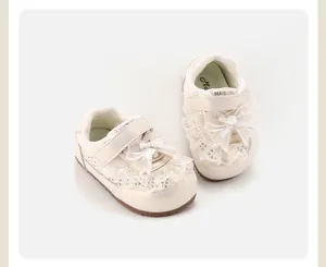 Elegant cream lace baby girl sneakers featuring decorative bows and non-slip rubber soles