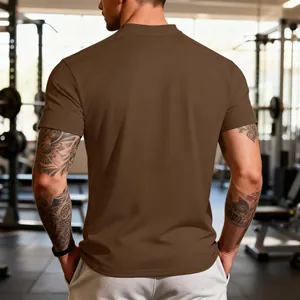 Professional back view of a men's brown moisture-wicking athletic T-shirt in a gym