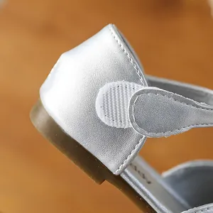 Close-up view of silver girls' princess shoe showing hook and loop fastener detail.