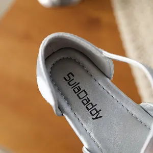 High-quality close-up of a silver children's dress shoe insole with logo details