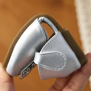 Close-up detail of silver girls' Mary Jane shoe showing its flexible soft sole for comfort.