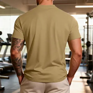 Back view showing the fit and texture of a tan athletic T-shirt in a gym setting
