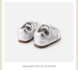 Detailed rear view of silver toddler shoes featuring white lace and bow accents
