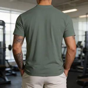 Back view of men's sage green quick-dry athletic t-shirt in a professional gym setting
