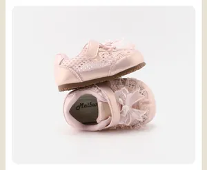 Detailed macro view of pink toddler girl shoes featuring delicate lace and bow accents