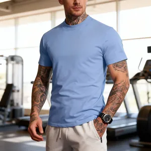 Close-up of a men's athletic light blue crew neck T-shirt in a professional gym setting