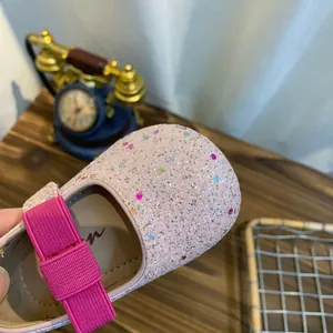 Close-up of sparkly pink glitter princess shoes for girls with colorful sequin details