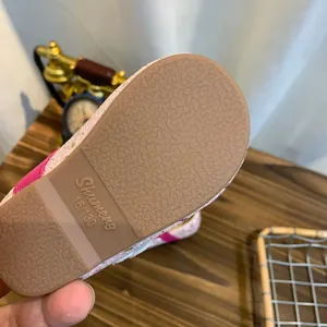 Close-up of the textured non-slip sole of a pink sparkly girls princess shoe