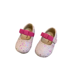 Sparkling pink glitter Mary Jane shoes for toddler girls with a bright bow strap
