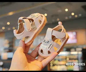 Close-up of pink toddler sandals with cute cartoon cat design and soft sole.