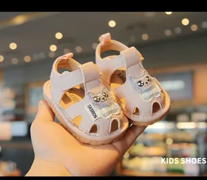 Close-up of pink baby sandals with a cute cartoon cat design and a flexible soft rubber sole