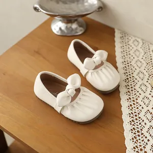 Vue détaillée des élégantes chaussures Mary Jane crème avec nœud et plis pour fillettes