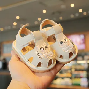 Adorable cream-colored infant sandals with cartoon cat patches and soft squeaky soles