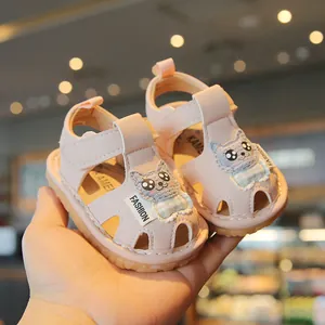 Pink soft-sole toddler sandals featuring cute cartoon cat designs for summer walking