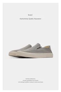 Detail view of stylish grey canvas slip-on loafers with retro rubber sole for men.