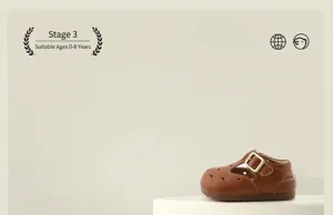 Close-up view of vintage brown leather baby t-strap shoes with buckle on a pedestal