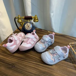 Gedetailleerde weergave van roze en lichtblauwe ademende kindersneakers met strikjes
