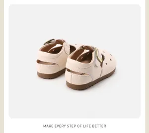Close-up view showing the back and soft rubber soles of beige baby hollow leather shoes