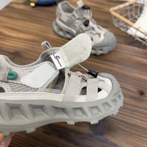 Macro detail of breathable mesh upper and rugged sole of children's outdoor sandal