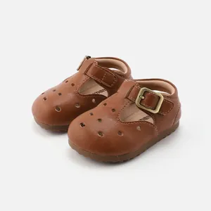 Classic brown leather T-strap baby shoes with soft non-slip soles and breathable cutouts