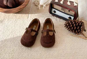 Classic vintage brown suede girls' T-bar Mary Jane shoes displayed in a cozy retro setting
