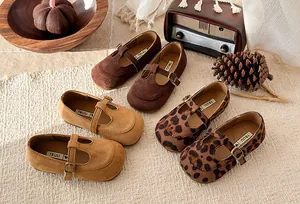 Detailed close-up of children's T-strap shoes in brown, tan, and leopard print options