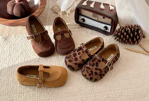 Detail of toddler girls' T-strap shoes in suede-like finish with vintage props