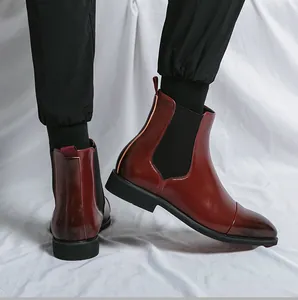 Side view detail of burgundy pointed-toe Chelsea boots for men with black elastic panels