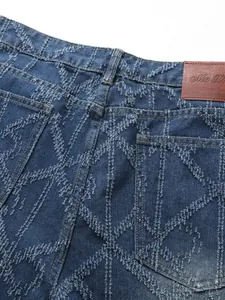 Detailed close-up of frayed diamond texture pattern on men's blue denim jeans back pocket